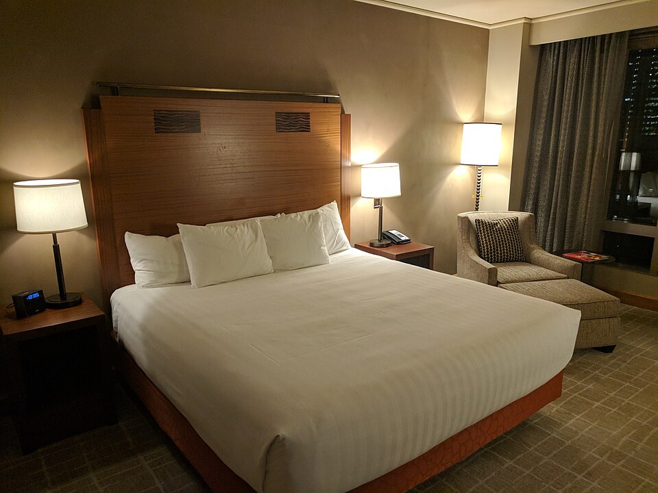 Neatly made bed with fresh pillows